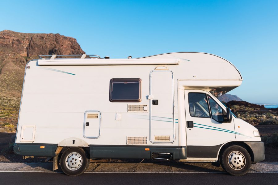 mobile house parked on asphalt route near picturesque view of blue heaven and mountain Teide in Tenerife, Canary Islands, Spain