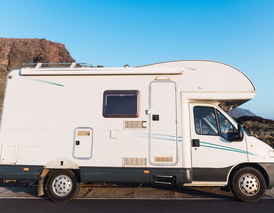 mobile house parked on asphalt route near picturesque view of blue heaven and mountain Teide in Tenerife, Canary Islands, Spain