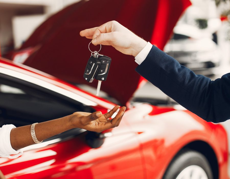 Stylish black woman in a car salon